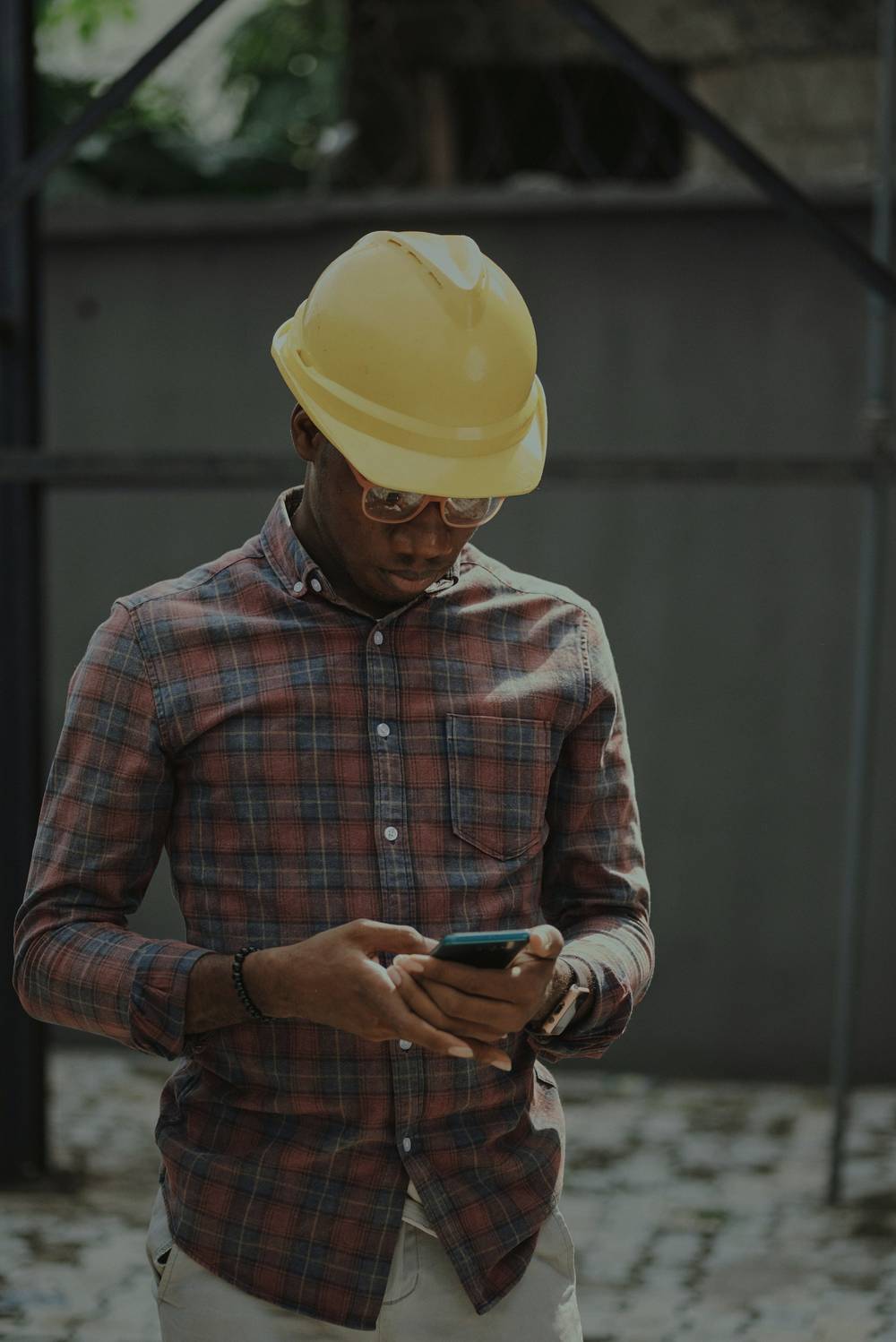 Paving contractor checking a new lead on his phone